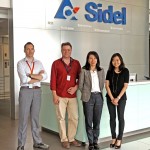 People in front of the Sidel Logo