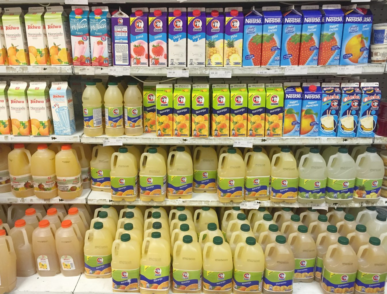 a shelf with different kinds of beverages in a supermarket