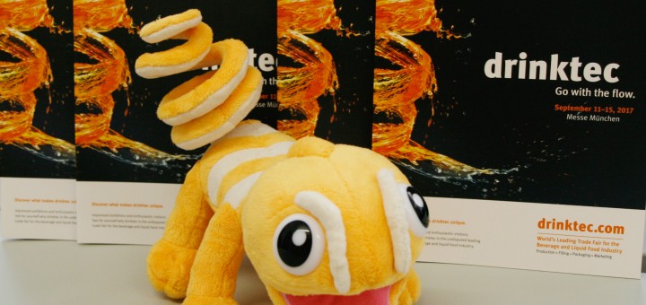 a stuffed animal on a table in front of drinktec brochures