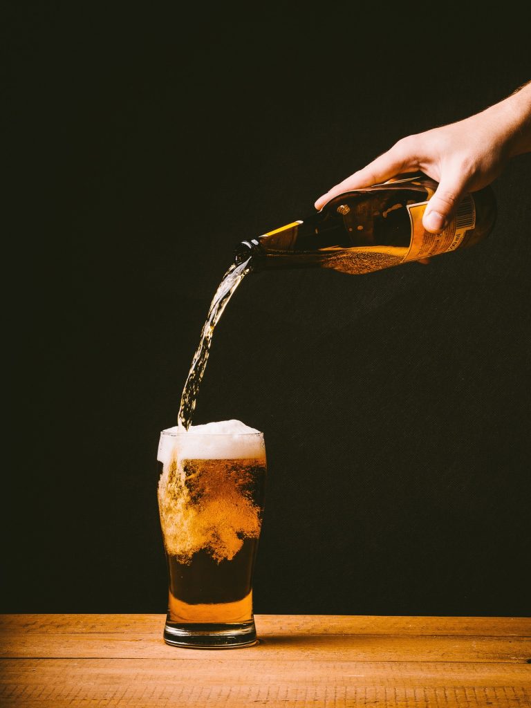 beer is being filled into a glass