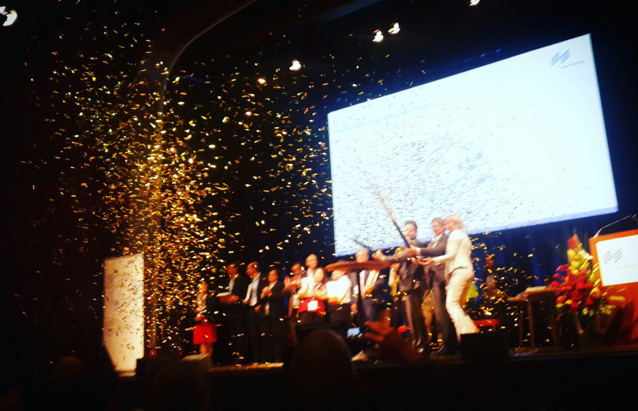 people on a stage celebrating with confetti