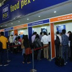 people standing in lines at the entrance at the drinktec India