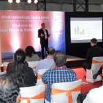 a man speaking on a stage at the exhibition forum at the drinktec India