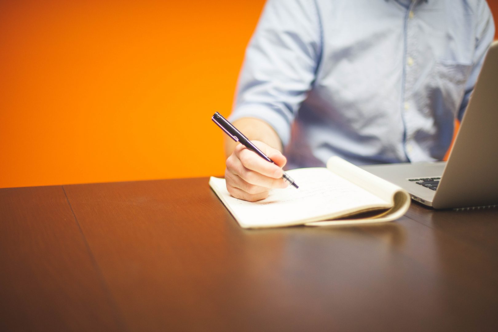 A person writing something into a note book