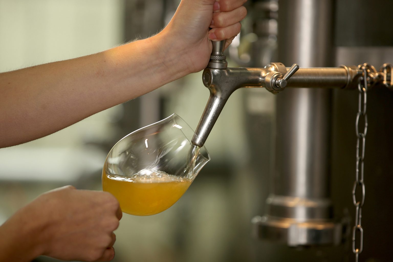 A person tapping beer