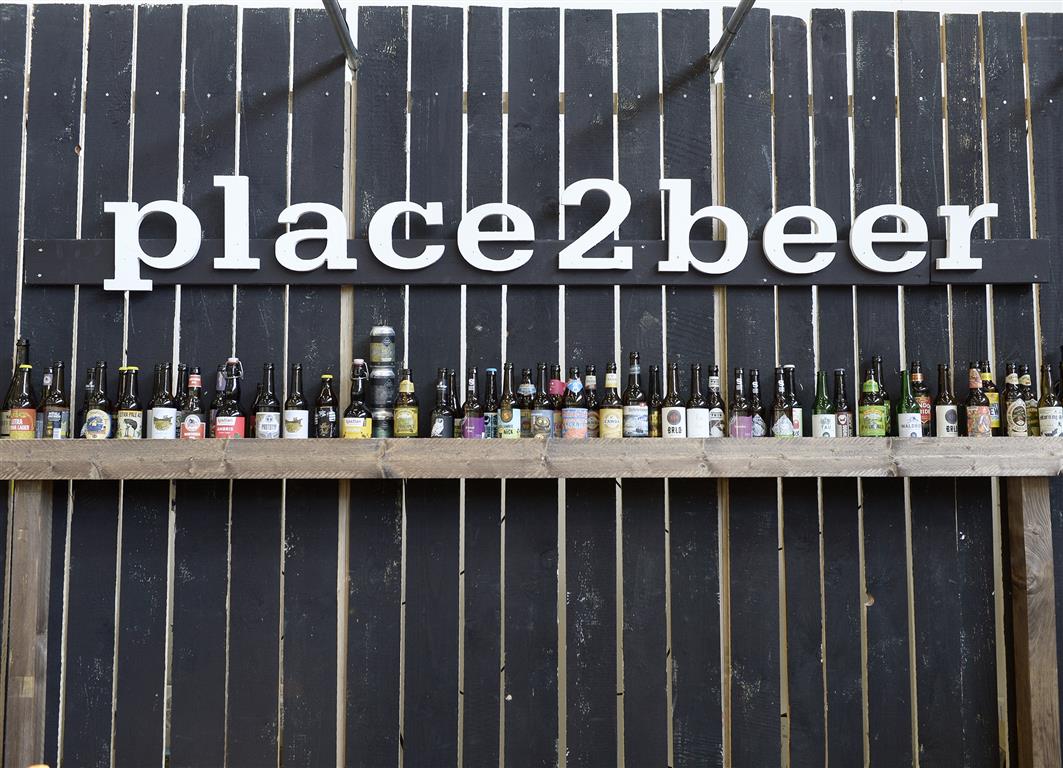 Bottles in a row with Place to Beer written over them