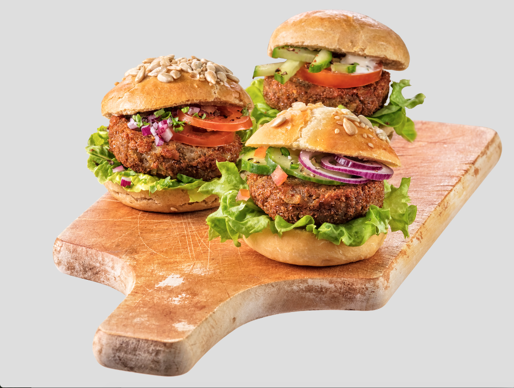 Three delicious looking burgers on a cutting board